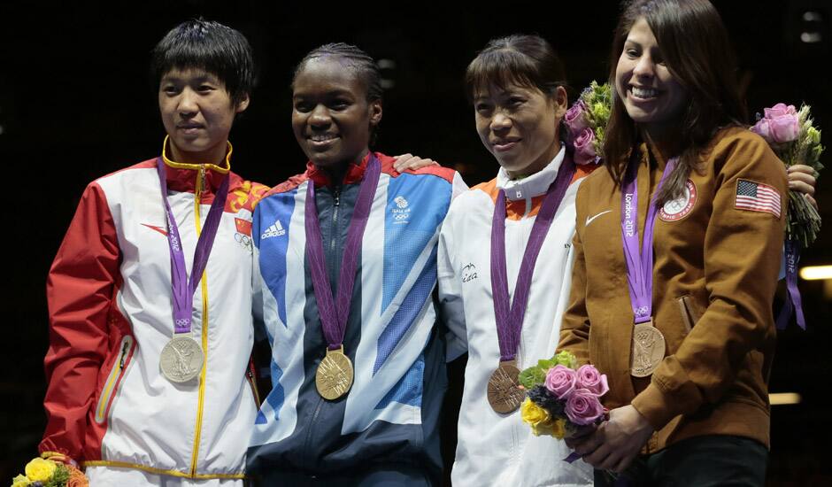 Silver medalist Ren Cancan, gold medalist Nicola Adams, bronze medalist, Mery Kom Hmangte, and bronze medalist Marlen Esparza, participate in the medals ceremony for women's final flyweight 51-kg gold medal boxing match at the 2012 Summer Olympics in London.