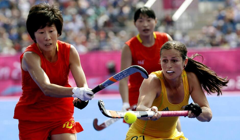 China's Gao Lihua (10) and Australia's Jayde Taylor (21) vie for the ball during their women's field hockey classification match at the 2012 Summer Olympics in London.