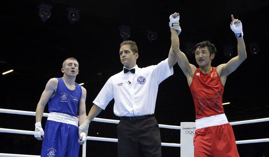 China's Zou Shiming reacts after beating Ireland's Paddy Barnes in a light flyweight 49-kg semifinal boxing match at the 2012 Summer Olympics in London.