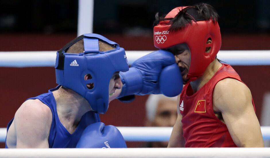 China's Zou Shiming, fights Ireland's Paddy Barnes, during their men's semifinal light flyweight 49-kg boxing match at the 2012 Summer Olympics in London.