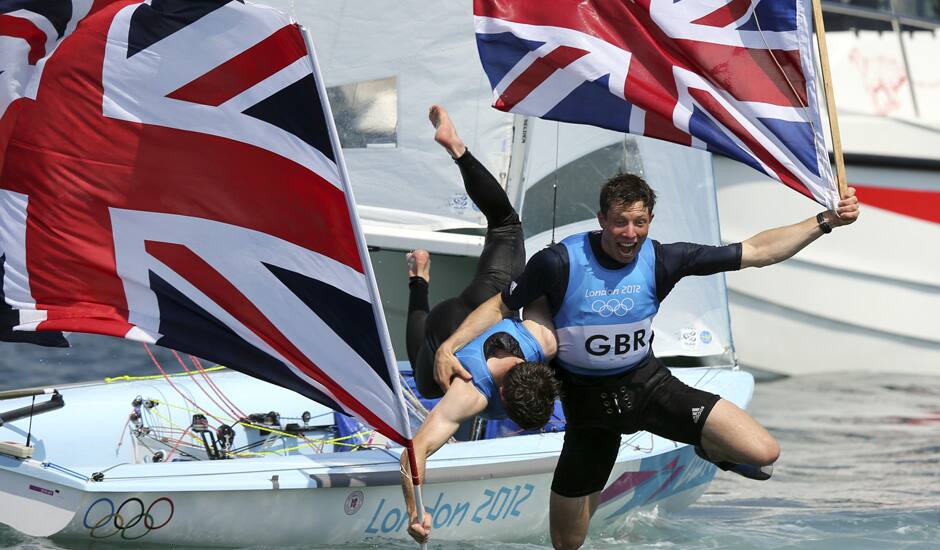 Luke Patience and Stuart Bithell of Great Britain celebrate their silver medal of the 470 men's two person dinghy sailing race at the London 2012 Summer Olympics in Weymouth and Portland, England.