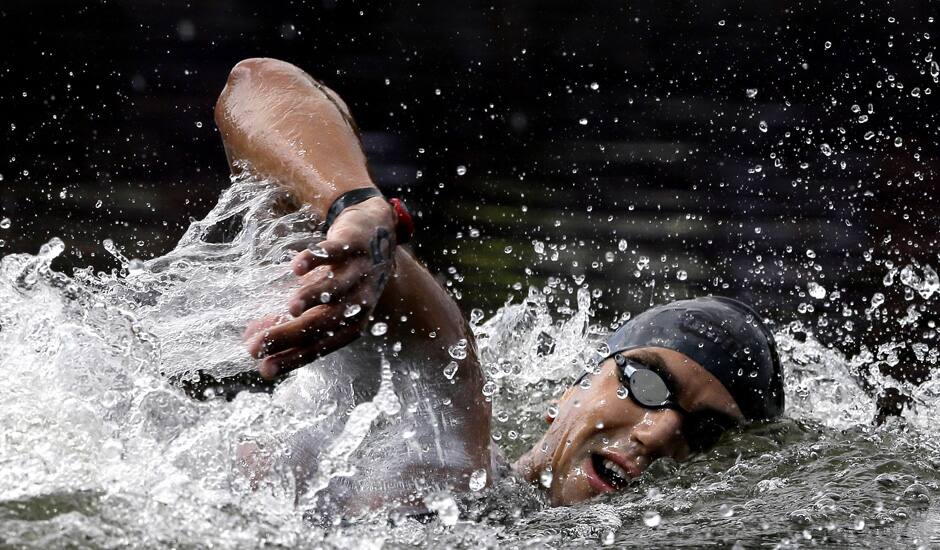 Tunisia's Oussama Mellouli swims during the men's 10-kilometer swimming marathon at the 2012 Summer Olympics in London. 