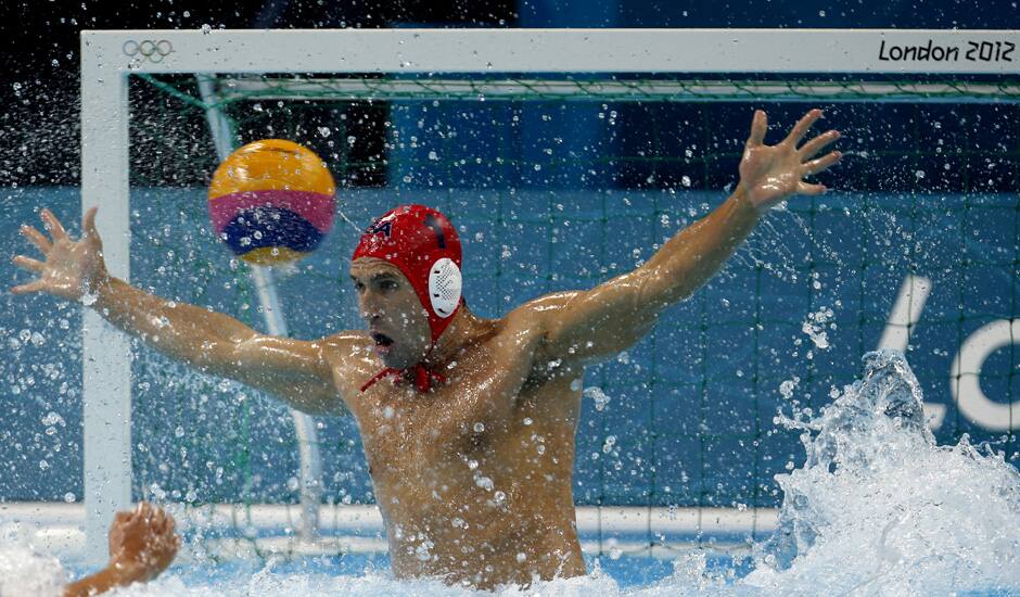 United States goalkeeper Merrill Moses is unable to stop a shot by Spain's Felipe Perrone Rocha during a men's semifinal fifth to eighth place water polo match at the 2012 Summer Olympics in London.