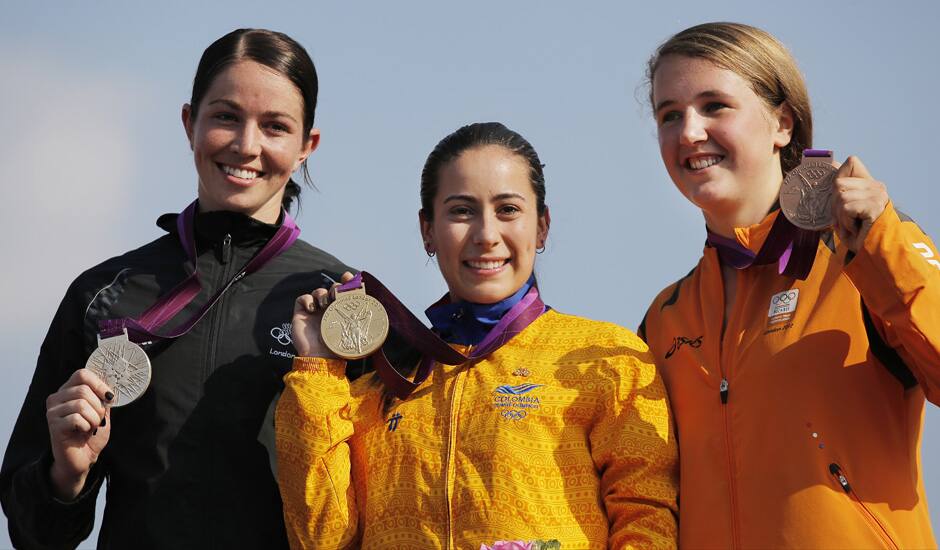 Gold medalist Mariana Pajon, of Colombia, poses for photographs with New Zealand's Sarah Walker, silver medalist, and Laura Smulders, of the Netherlands, with the bronze medal for women's BMX cycling during the 2012 Summer Olympics in London.