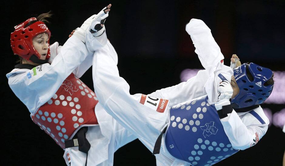 France's Anne-Caroline Graffe fights Uzbekistan's Natalya Mamatova (in red) during their match in women's plus 67-kg taekwondo competition at the 2012 Summer Olympics in London.