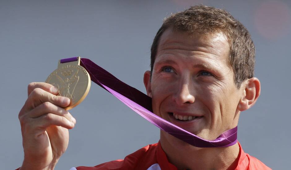 Great Britain's Ed McKeever displays the gold medal he won in the men's kayak single 200m in Eton Dorney, near Windsor, England, at the 2012 Summer Olympics.