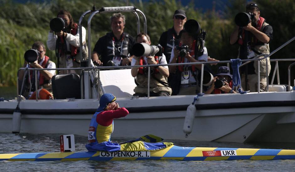 Ukraine's Inna Osypenko-Radomska gestures to photographers after winning the silver medal in the women's kayak single 200m in Eton Dorney, near Windsor, England, at the 2012 Summer Olympics.