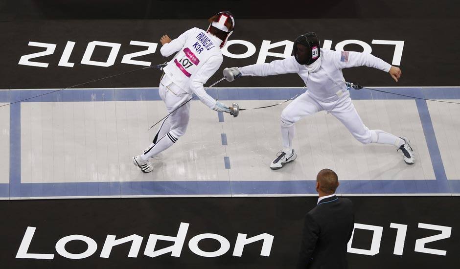 Hwang Woojin of South Korea, left, defeats Dennis Bowseher of the United States during the men's fencing section of the modern pentathlon at the 2012 Summer Olympics.