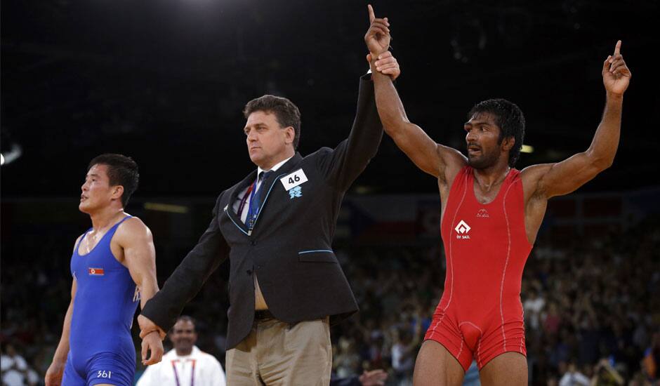 Yogeshwar Dutt of India reacts after beating Ri Jong Myong of North Korea for the bronze medal during the men's 60-kg freestyle wrestling competition at the 2012 Summer Olympics in London