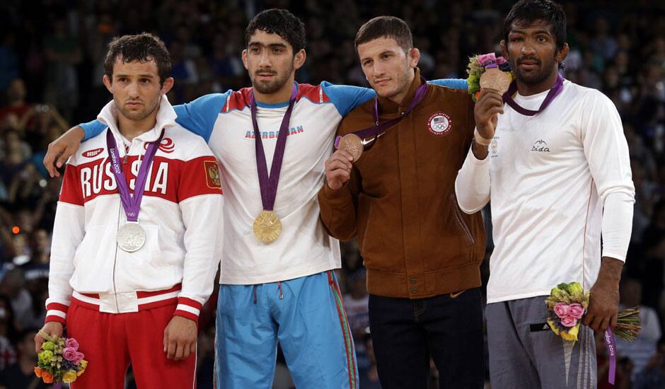 The medalists pose with their medals after the victory ceremony for the men's 60-kg freestyle wrestling competition at the 2012 Summer Olympics in London. Seen from left to right are, Besik Kudukhov of Russia, Toghrul Asgarov of Azerbaijan, Coleman Scott of the United States and Yogeshwar Dutt of India