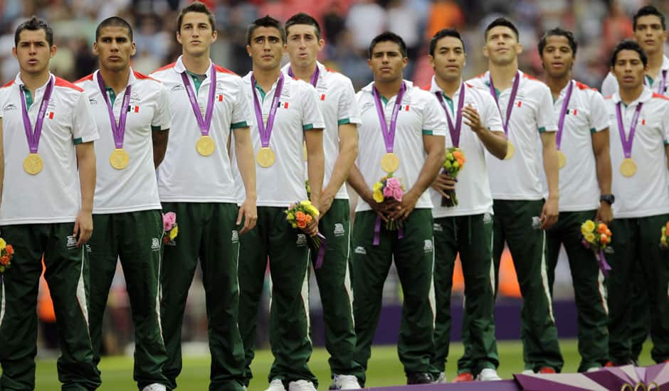 Mexico players stand on the podium with their gold medals during a ceremony following the men's soccer final between Brazil and Mexico at the 2012 Summer Olympics in London