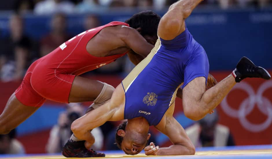 Besik Kudukhov of Russia competes against Yogeshwar Dutt of India (in red) during the men's 60-kg freestyle wrestling competition at the 2012 Summer Olympics.