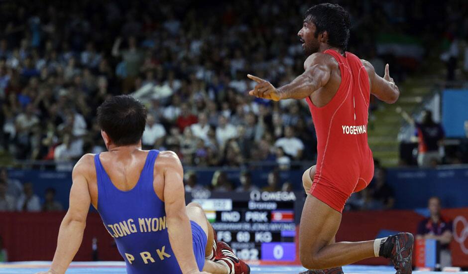 Yogeshwar Dutt of India celebrates after beating Ri Jong Myong of North Korea for the bronze medal during the men's 60-kg freestyle wrestling competition at the 2012 Summer Olympics.