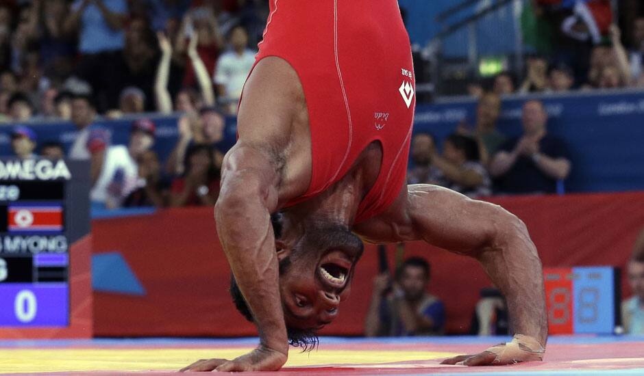 Yogeshwar Dutt of India celebrates after beating Ri Jong Myong of North Korea for the bronze medal during the men's 60-kg freestyle wrestling competition at the 2012 Summer Olympics.