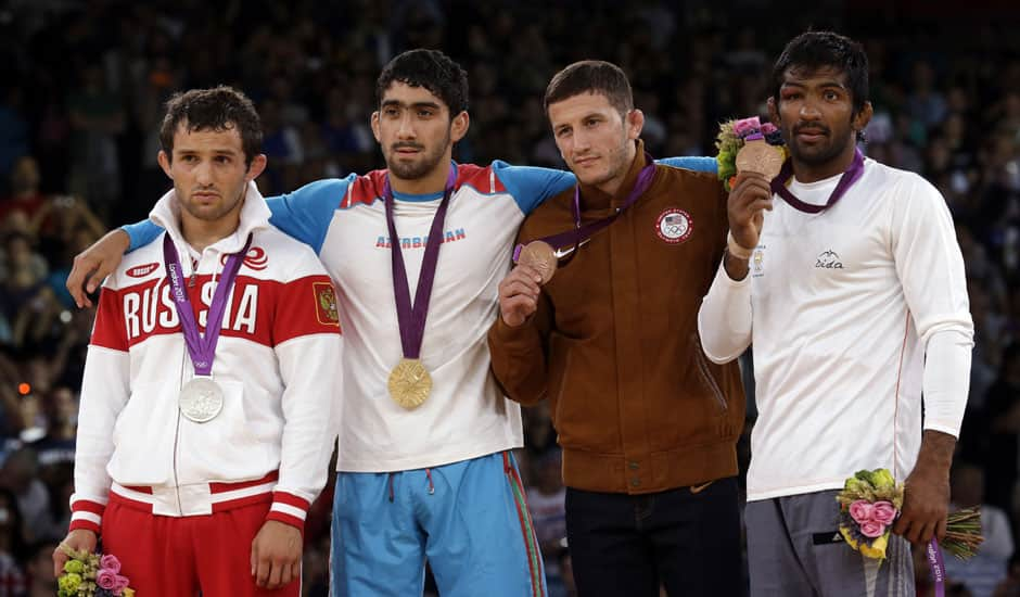 The medalists pose with their medals after the victory ceremony for the men's 60-kg freestyle wrestling competition at the 2012 Summer Olympics.