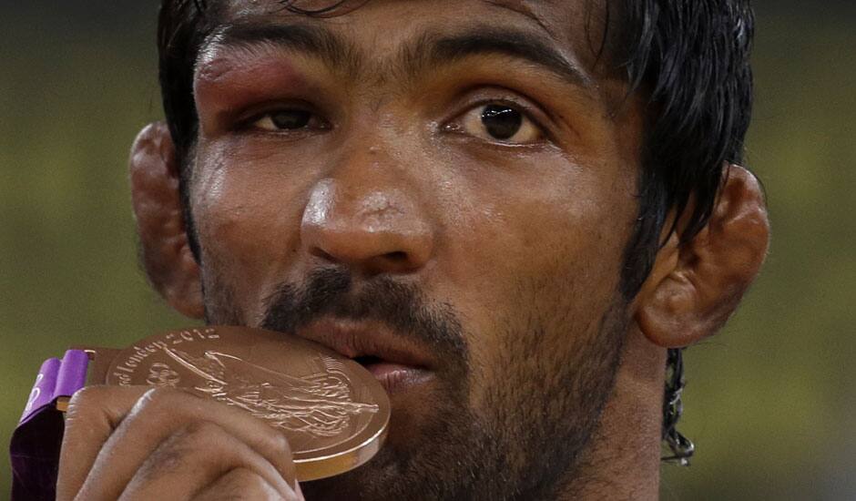 Bronze medalist Yogeshwar Dutt of India poses with his medal during the victory ceremony for the men's 60-kg freestyle wrestling competition at the 2012 Summer Olympics.