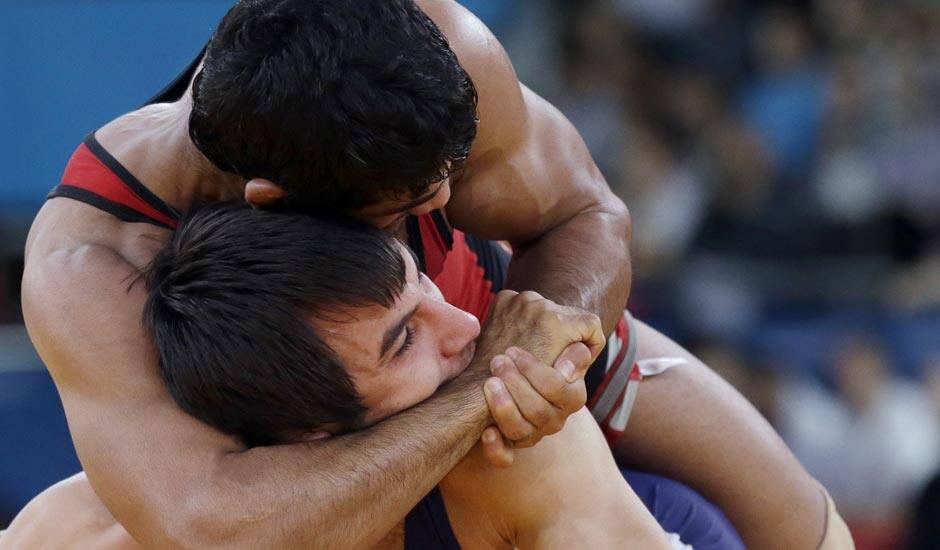 Sushil Kumar of India (in red) and Ramazan Sahin of Turkey, (in blue) compete during their 66-kg freestyle wrestling match at the 2012 Summer Olympics.