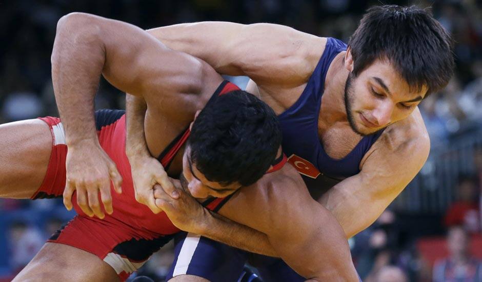 Sushil Kumar of India, competes with Ramazan Sahin of Turkey, (in blue) during their 66-kg freestyle wrestling match at the 2012 Summer Olympics.