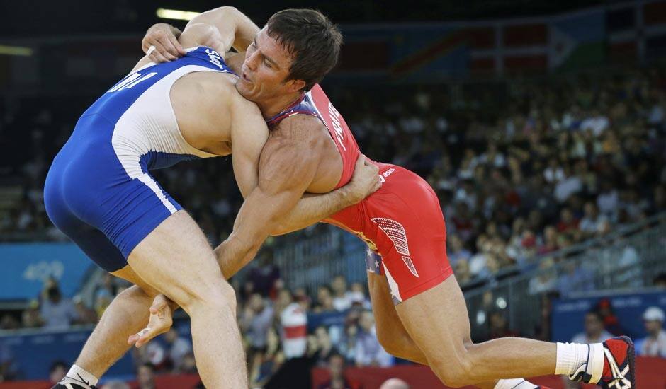 Jared Frayer of the United States, competes with Ali Shabanau of Belarus, (in blue) during their 66-kg freestyle wrestling match at the 2012 Summer Olympics.