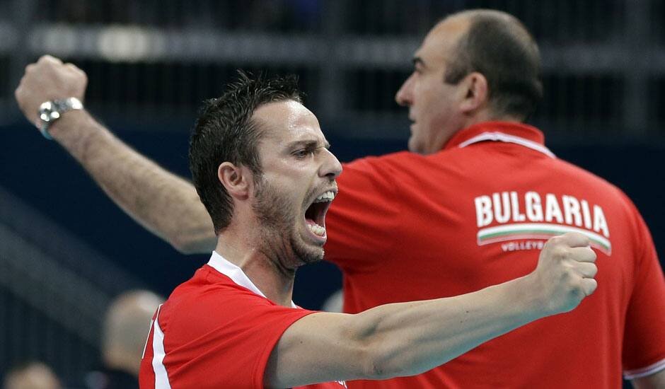 Bulgaria's Teodor Salparov (13, front) and coach Nayden Naydenov react after scoring a point against Italy during a men's volleyball bronze medal match at the 2012 Summer Olympics.