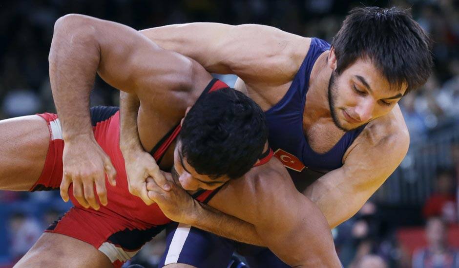 Sushil Kumar, competes with Ramazan Sahin of Turkey, (in blue) during their 66-kg freestyle wrestling match at the 2012 Summer Olympics.