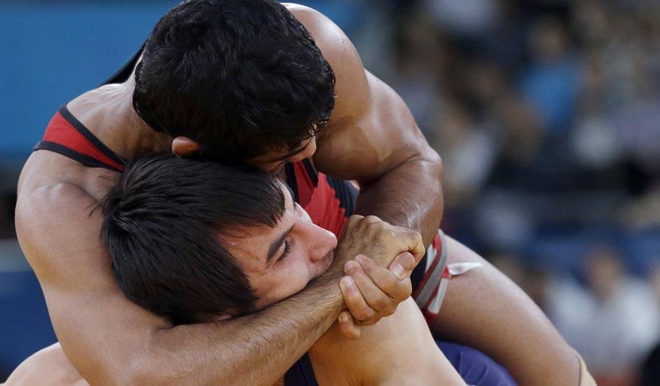 Sushil Kumar (in red) and Ramazan Sahin of Turkey, (in blue) compete during their 66-kg freestyle wrestling match at the 2012 Summer Olympics.