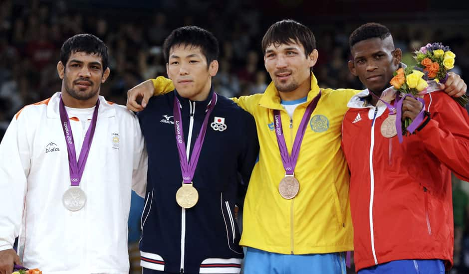 From left, silver medalist Sushil Kumar of India, gold medalist Tatsuhiro Yonemitsu of Japan, bronze medalist Akzhurek Tanatarov of Kazakhstan, and bronze medalist Livan Lopez Azcuy of Cuba, participate in the medals ceremony for men's 66-kg freestyle wrestling at the 2012 Summer Olympics in London