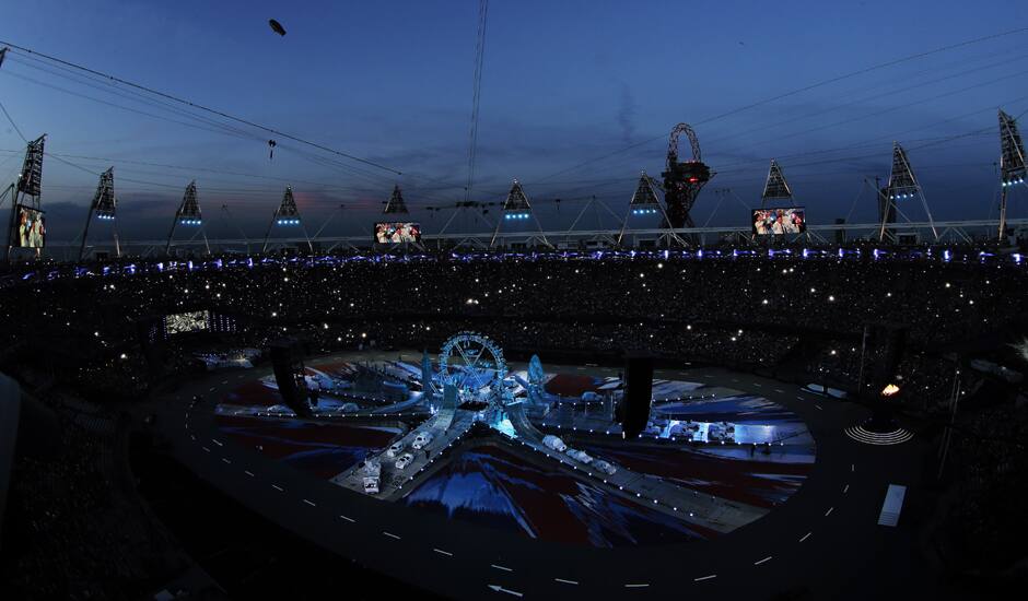 Fans take pictures in the Olympic Stadium before the start of the Closing Ceremony at the 2012 Summer Olympics, Sunday.