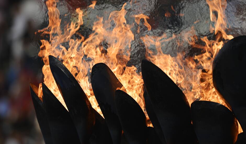 The Olympic flame burns in the Olympic Stadium before the start of the Closing Ceremony at the 2012 Summer Olympics, Sunday