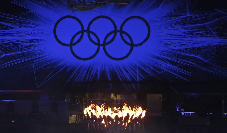 The Olympic Flame burns as the Olympic Rings stand illuminated during the Closing Ceremony at the 2012 Summer Olympics, Sunday, Aug. 12, 2012, in London.