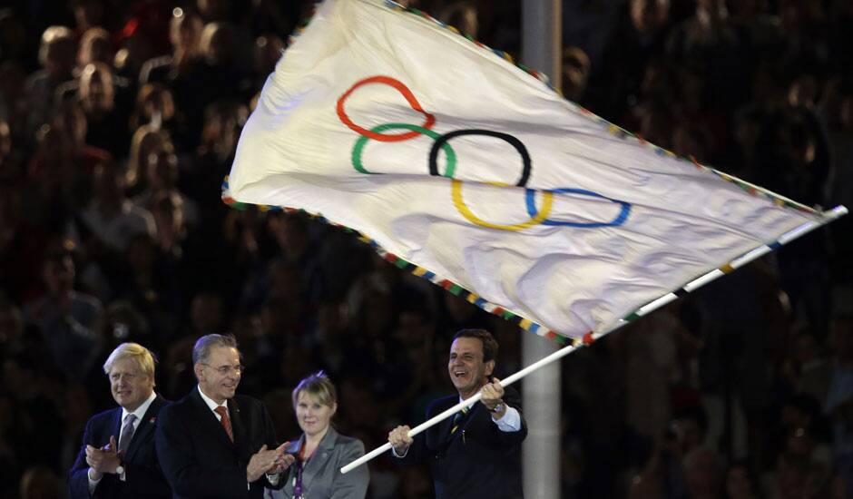 Rio de Janeiro mayor Eduardo Paes waves the olympic flag next to Jacques Rogge and London Mayor Boris Johnson, left, during the Closing Ceremony at the 2012 Summer Olympics, Sunday, Aug. 12, 2012, in London.