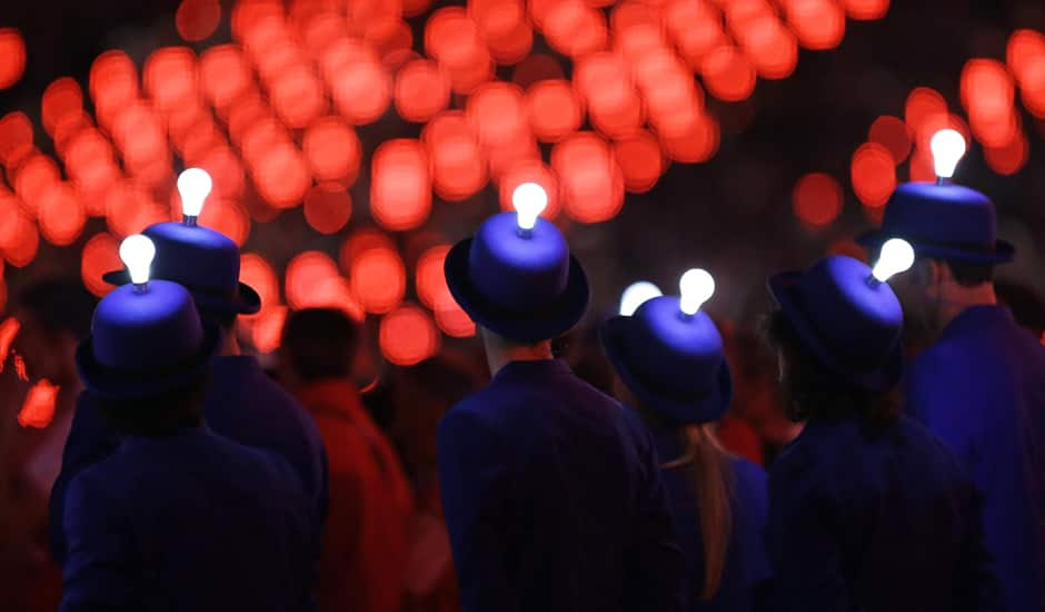 Light bulbs glow on the heads of performers during the Closing Ceremony at the 2012 Summer Olympics, Sunday, Aug. 12, 2012, in London