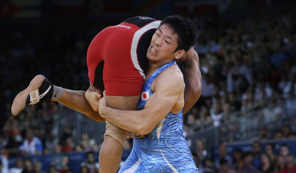 Sushil Kumar of India competes with Tatsuhiro Yonemitsu of Japan (in blue) during their 66-kg freestyle wrestling gold medal match at the 2012 Summer Olympics.