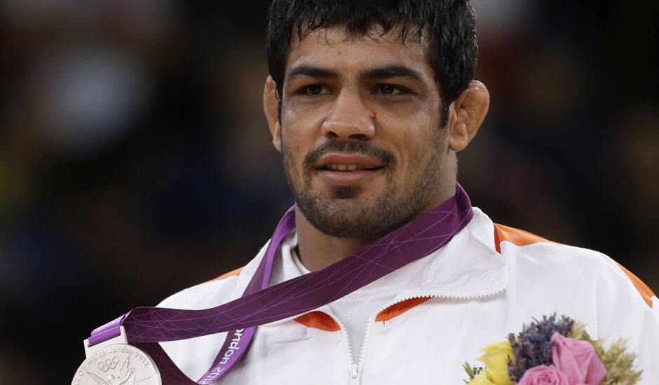 Sushil Kumar of India reacts during the victory ceremony after winning the silver medal in 66-kg freestyle wrestling at the 2012 Summer Olympics.