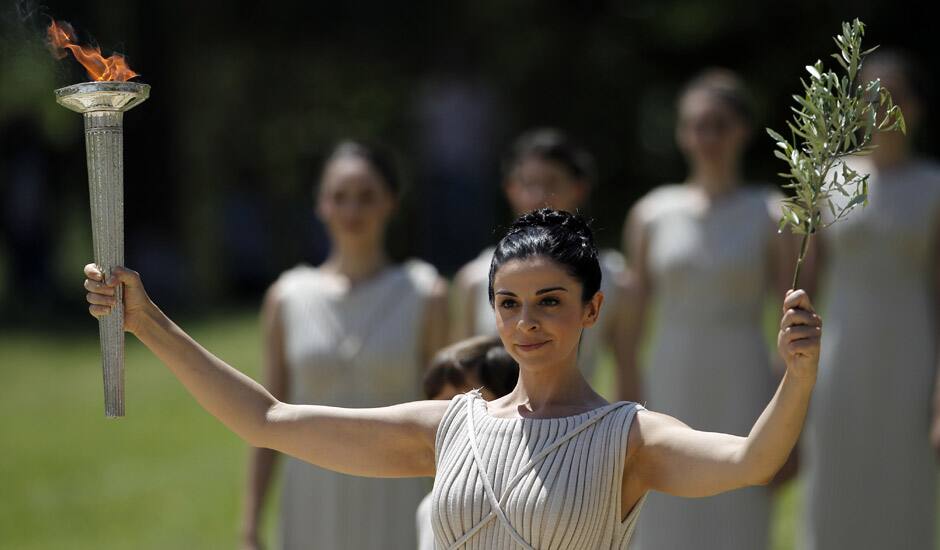 Actress Ino Menegaki, dressed as a high priestess, lights the torch at a ceremony in Panathinean stadium in Athens. The torch begins its 70-day journey to arrive at the opening ceremony of the London 2012 Olympics, from the Greek capital