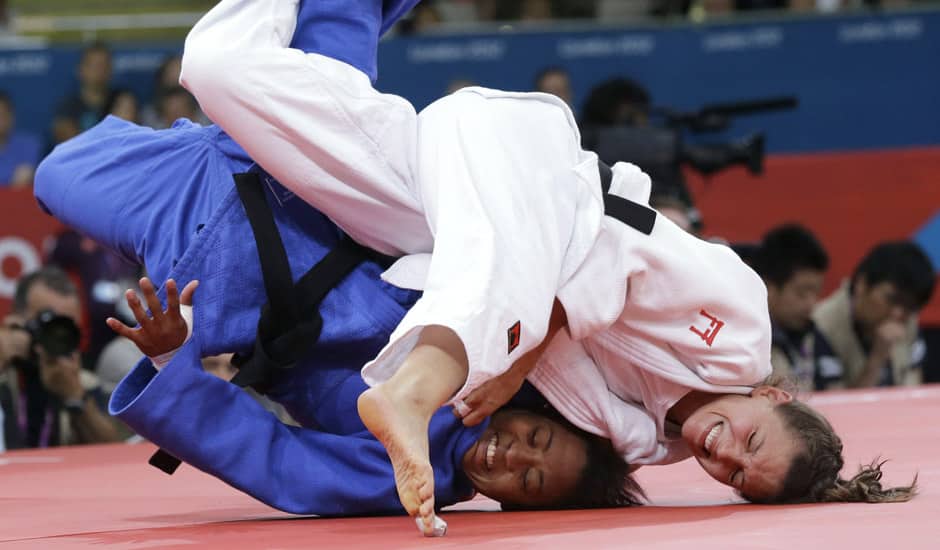 Luxembourg's Marie Muller, right, competes with Mauritius's Christianne Legentil during the women's 52-kg judo competition at the 2012 Summer Olympics in London