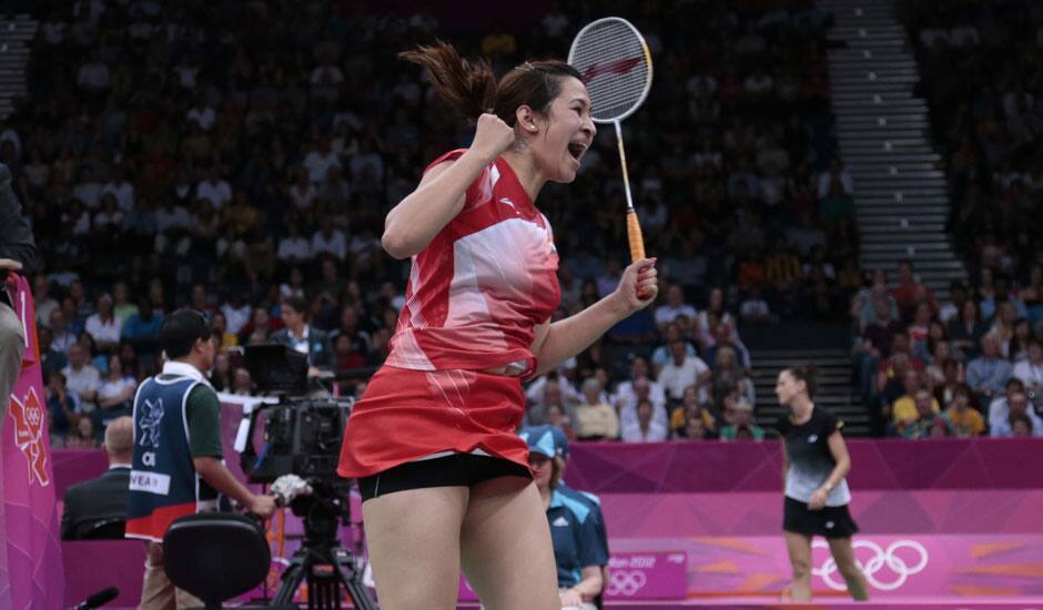 India's Jwala Gutta jumps up after winning against Taiwan's Cheng Wen-hsing and Chien Yu-chin, unseen, at a women's doubles badminton match of the 2012 Summer Olympics.