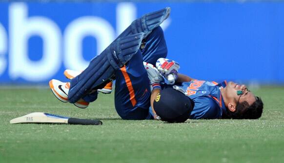 Prashant Chopra of India lies on the ground after being injured while batting against New Zealand during their ICC U19 Cricket World Cup 2012 semi-final match in Townsville, Australia.