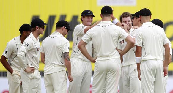 New Zealand bowler Trent Boult celebrates the dismissal of Indian cricketer Virender Sehwag during the first day of their first cricket test match in Hyderabad.