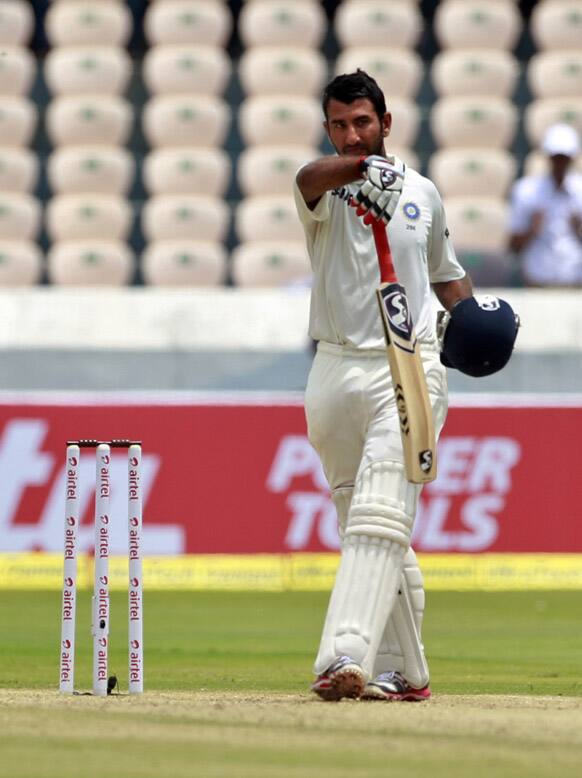 Cheteshwar Pujara reacts after scoring 150 runs during the second day of the first cricket test match against New Zealand in Hyderabad.