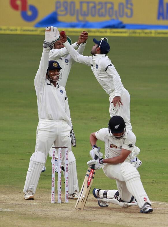 Mahendra Singh Dhoni, and Virat Kohli, appeals successfully for the dismissal of New Zealand cricketer Daniel Flynn during the second day of the first cricket test match in Hyderabad.