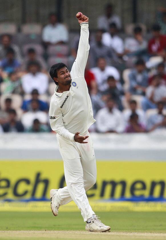 Pragyan Ojha bowls during the third day of the first cricket test match against New Zealand in Hyderabad.