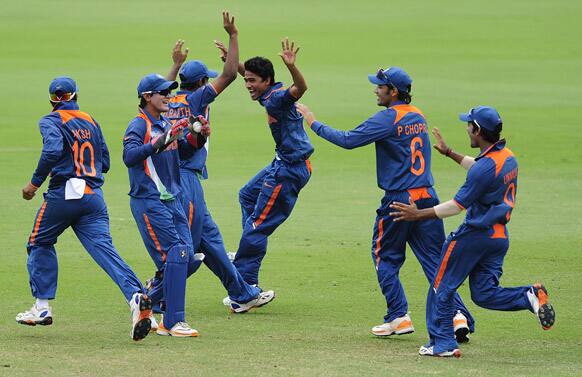 This photo provided by the International Cricket Council, India's Ravi Kant Singh, center, celebrates with teammates the dismissal of Myerick Buchanan of Australia during the 2012 ICC under-19 Cricket World Cup final .