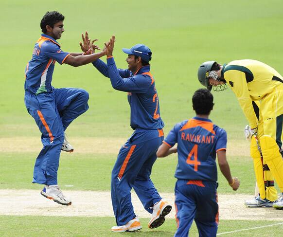 Baba Aparajith, celebrates with teammates the dismissal of Australia's Kurtis Patterson, right, during the 2012 ICC under-19 Cricket World Cup final, in Townsville