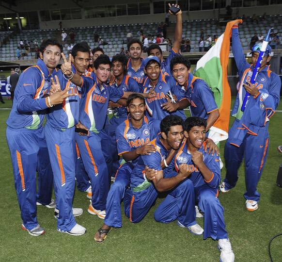 Indian players pose for photos as they celebrate their victory over Australia in the 2012 ICC U19 Cricket World Cup final in Townsville, Australia.