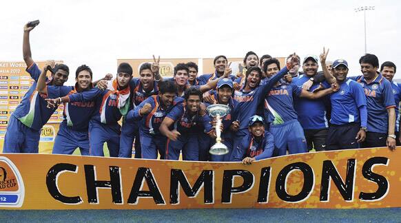 Indian players pose for photos as they celebrate their victory over Australia in the the 2012 ICC U19 Cricket World Cup final in Townsville, Australia.