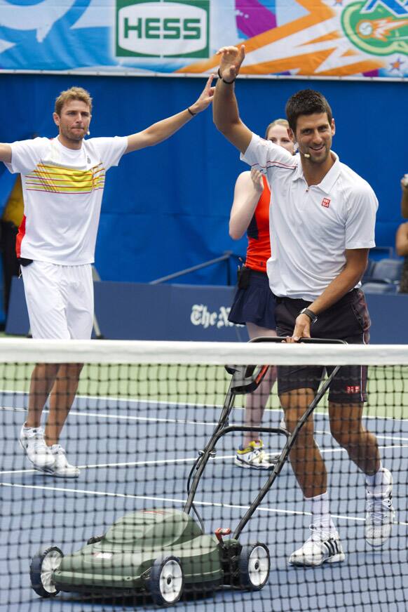 Tennis player Novak Djokovic, right, dances and sings along to 