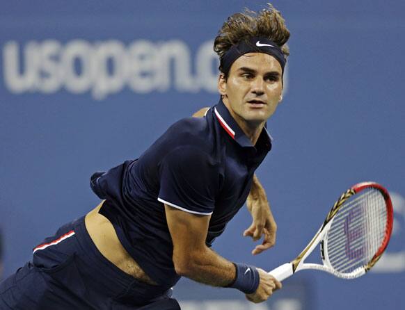 Roger Federer, of Switzerland, serves to Donald Young in the first round of play at the U.S. Open tennis tournament.