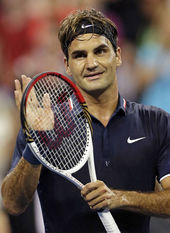 Roger Federer, of Switzerland, acknowledges the crowd after defeating Donald Young 6-3, 6-2, 6-4 in the first round of play at the U.S. Open tennis tournament.