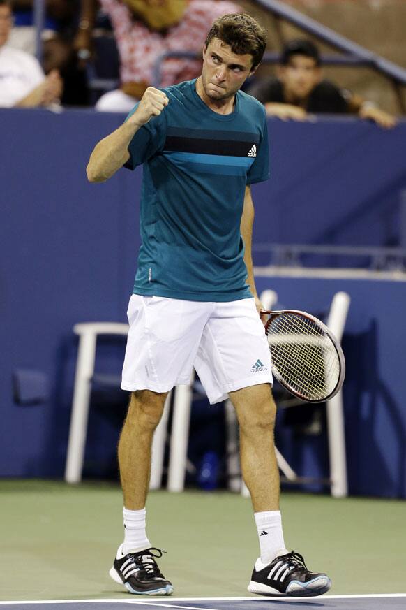 Gilles Simon, of France, reacts after defeating Michael Russell 7-6 (4), 3-6, 5-7, 6-4, 6-1 in a match at the U.S. Open tennis tournament.